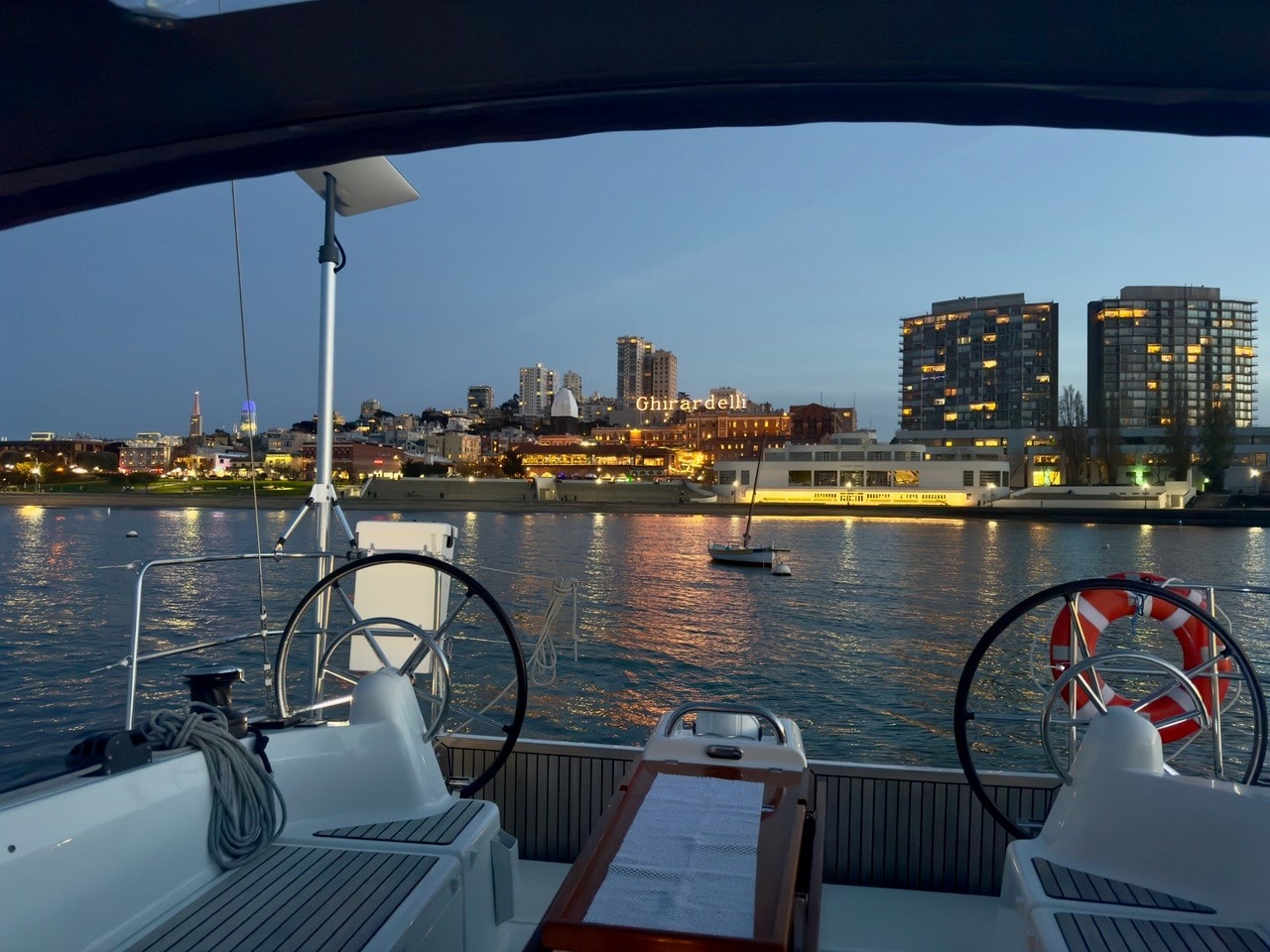 Cockpit view aboard Rabbit Hole heeling in a breeze with the Golden Gate behind