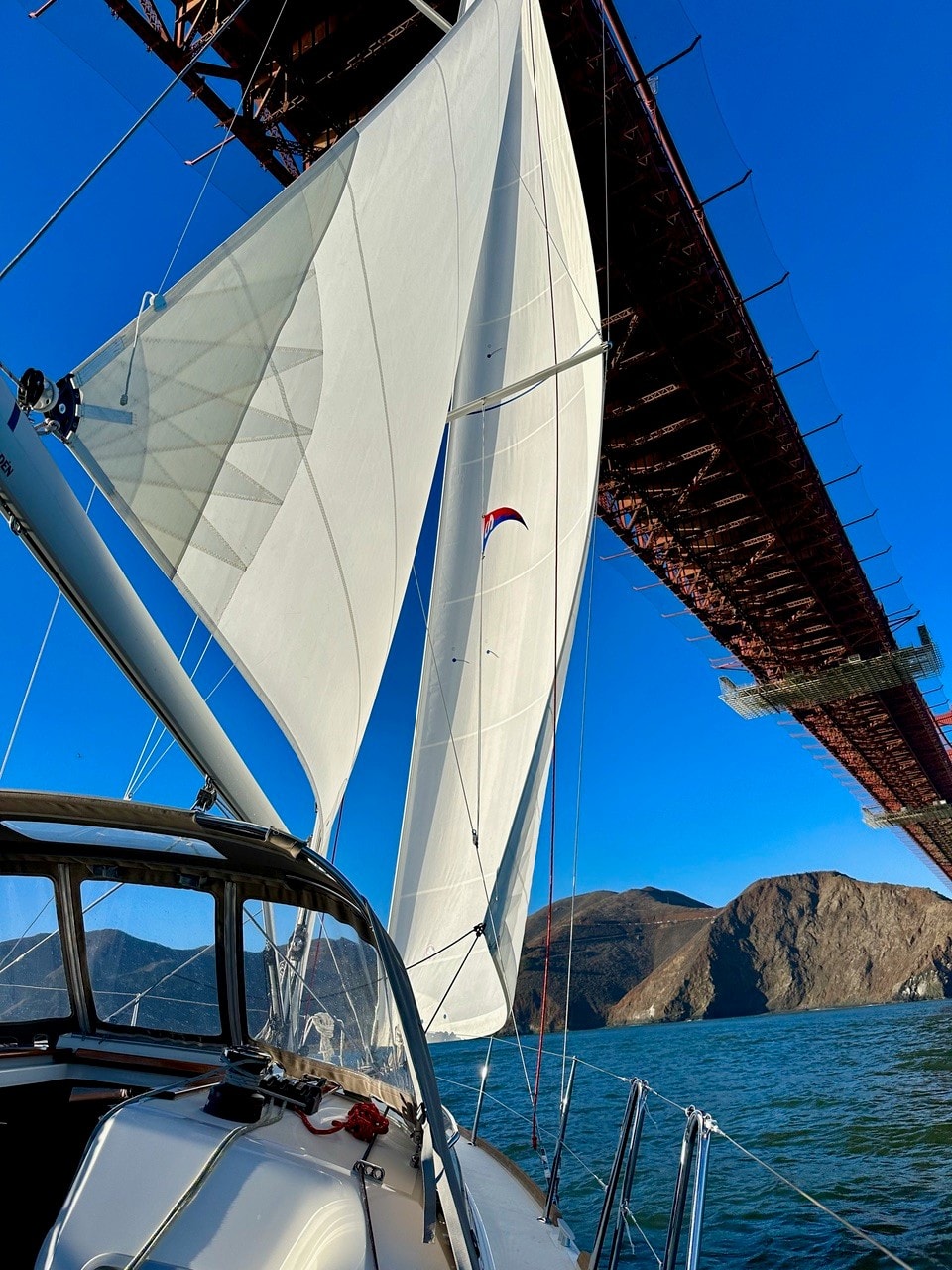 SV Rabbit Hole stern with San Francisco skyline and Bay Bridge